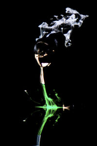 Close-up of lamp over black background