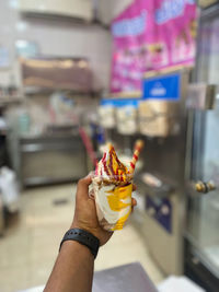 Close-up of hand holding ice cream cone