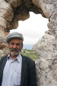 Portrait of man standing on rock