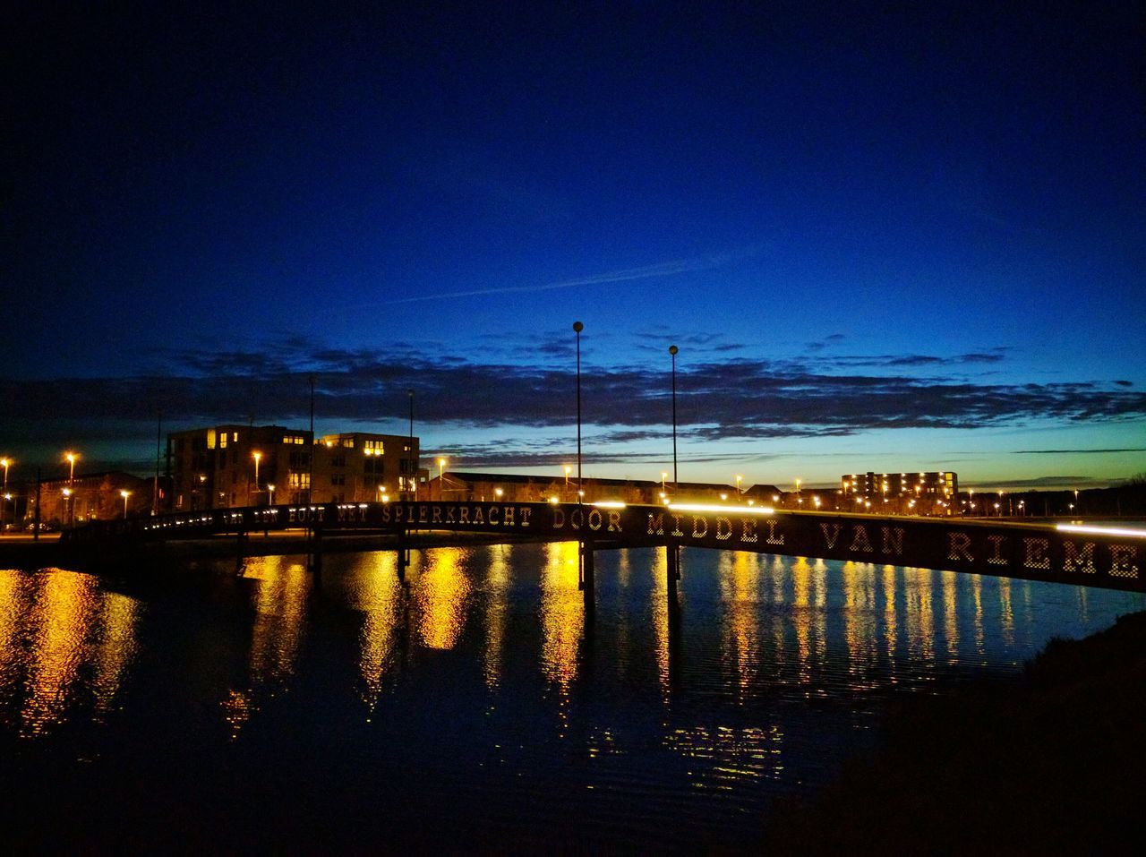 REFLECTION OF ILLUMINATED BUILDINGS IN WATER