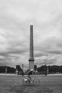 View of monument in city against cloudy sky