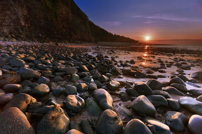 Rocks on beach against sky