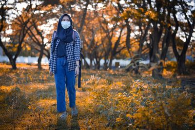 Man standing on field during autumn