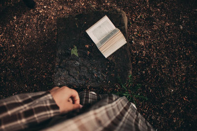 Low section of person on book