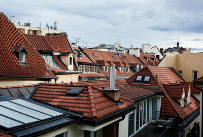 Houses against cloudy sky