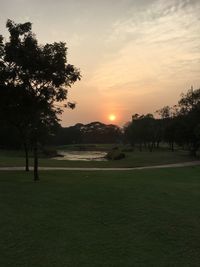 Scenic view of field against sky during sunset