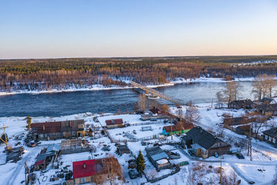Aerial view of town by river during winter