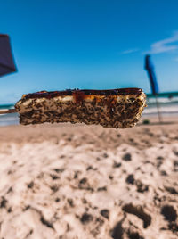 Close-up of chocolate cake on sand