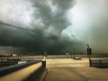 Parking lot against cloudy sky