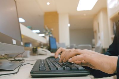 Midsection of man working on table