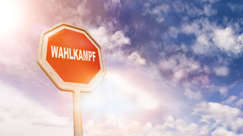 Low angle view of road sign against sky