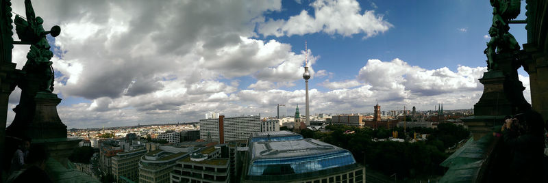 Buildings against cloudy sky