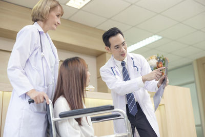 Portrait of female doctor examining patient in hospital