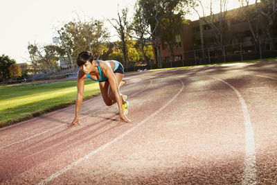 Woman preparing for running on sports track