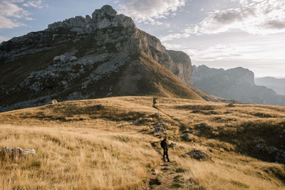 Scenic view of field and mountains against sky