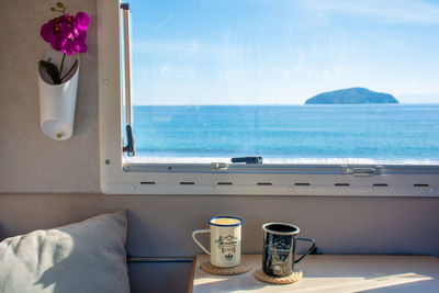 Low section of woman sitting on bed at home