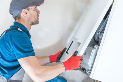 Side view of man working in electrical equipment