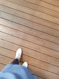 Low section of man on wooden floor