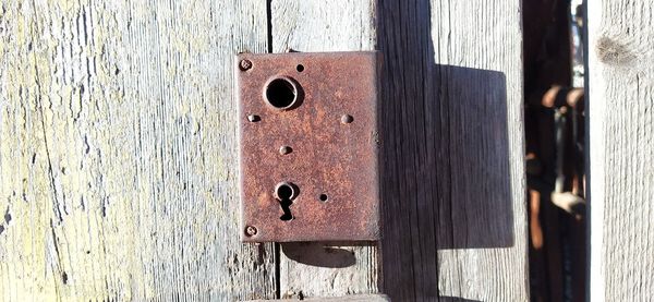 Rusty door hinge on wooden door