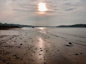 Scenic view of beach against sky during sunset