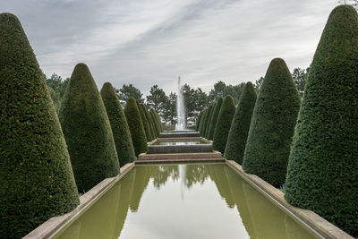 Panoramic view of garden against cloudy sky