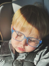 Close-up portrait of young woman in car