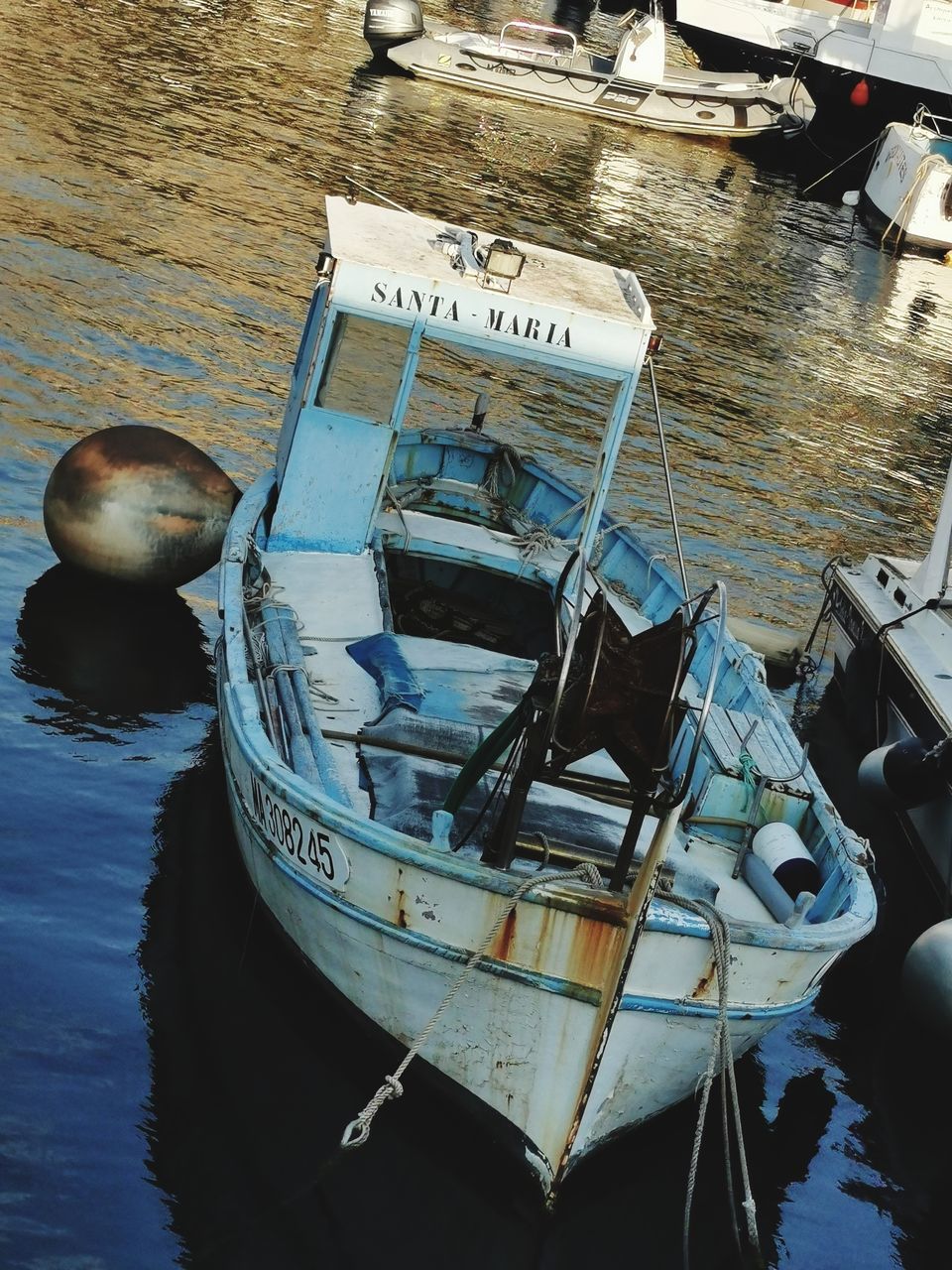 HIGH ANGLE VIEW OF BOAT MOORED AT HARBOR