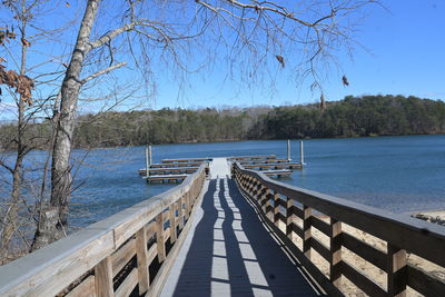 Pier over lake against clear sky