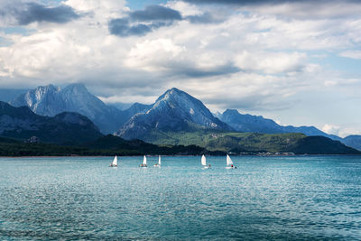 Scenic view of sea and mountains against sky