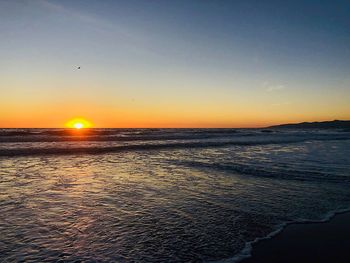 Scenic view of sea against clear sky during sunset