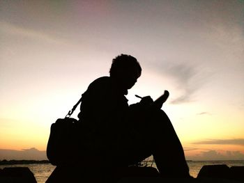 Silhouette of woman at sunset