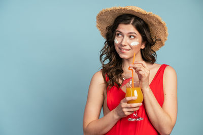 Portrait of a young woman drinking drink