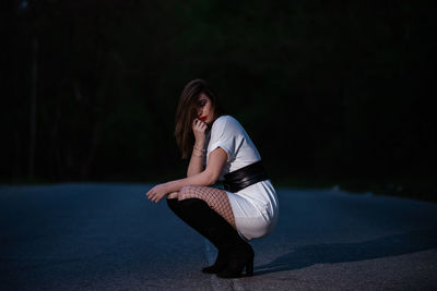 Portrait of young woman sitting outdoors