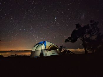 Tent on field against sky at night