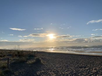 Scenic view of beach against sky during sunset
