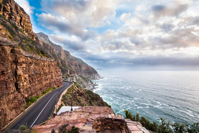 Scenic view of sea and mountains against sky