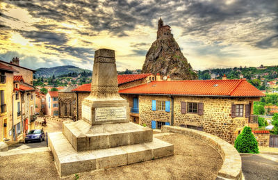 Buildings in city against sky during sunset