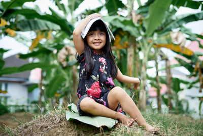 Portrait of a smiling girl sitting on field