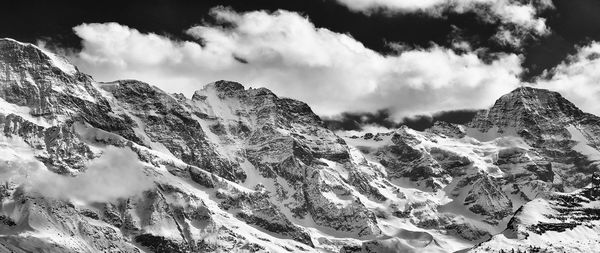 Panoramic shot of snowcapped jungfrau against cloudy sky