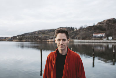 Man at lake looking at camera