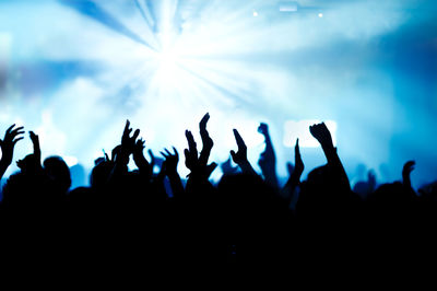 Crowd enjoying at music concert at night