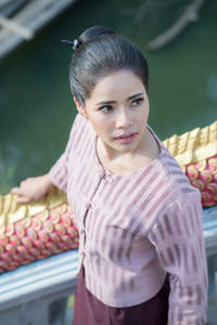 High angle view of woman standing by railing on staircase