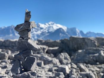 Stack of rocks against sky during winter