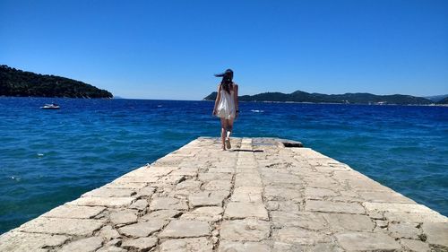 Scenic view of sea against clear blue sky