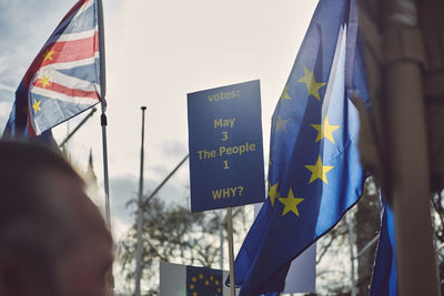 Low angle view of flags against blue sky