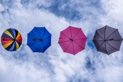 Low angle view of umbrellas against sky