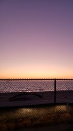 Fence against clear sky during sunset