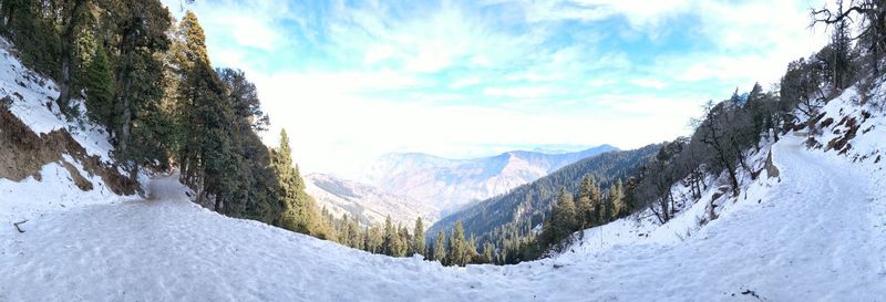 Panoramic view of snowcapped mountains against sky