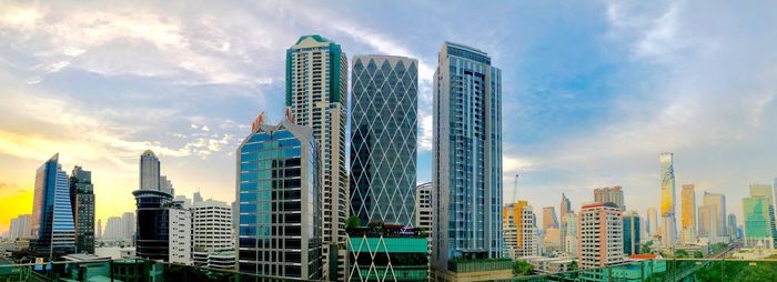 Panoramic view of modern buildings against sky in city