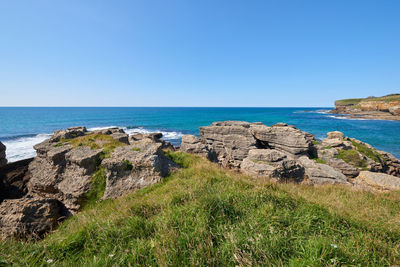 Scenic view of sea against clear blue sky